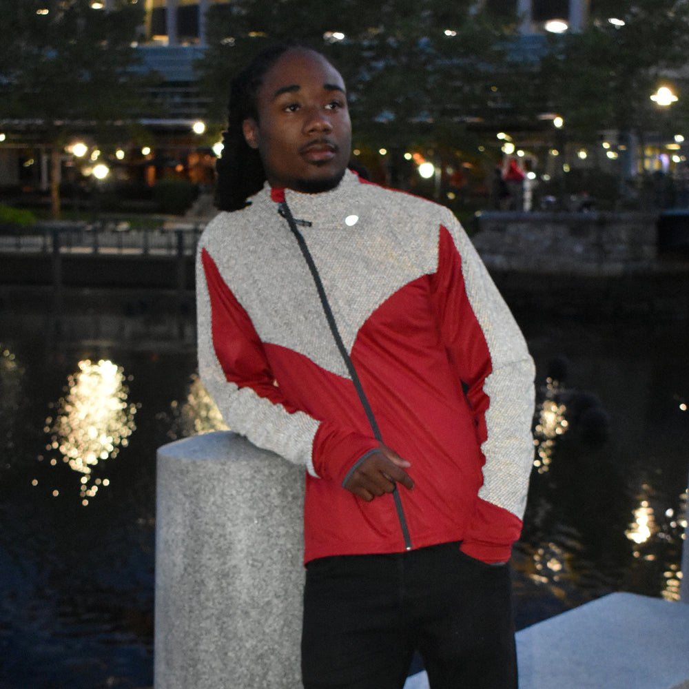 A man leaning on a bike wearing a neon reflective jacket